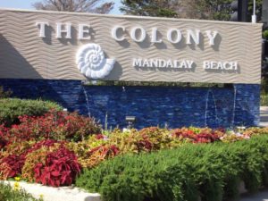 The Colony Mandalay Beach sign and waterfall.